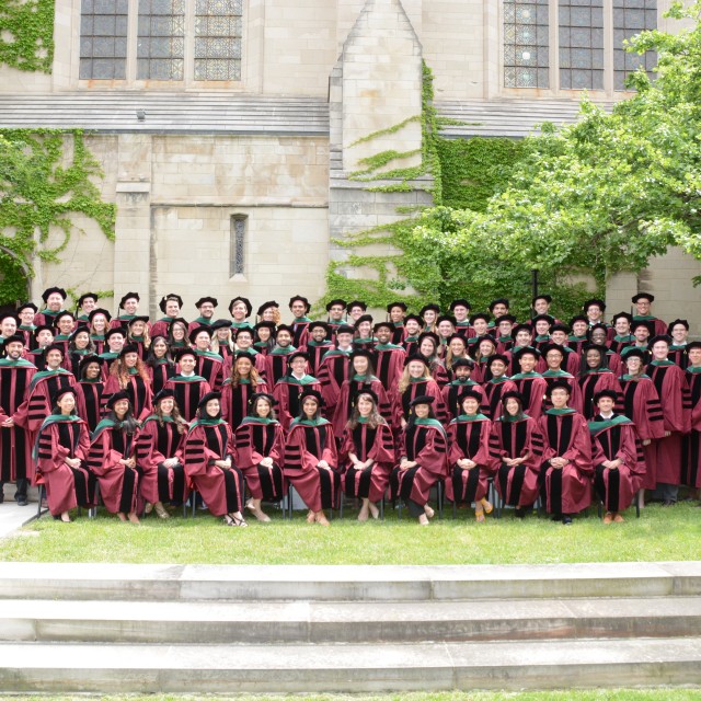 Photo of a graduating class of Pritzker students in regalia