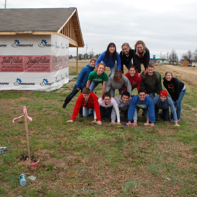 Pritzker students posing in a pyramid